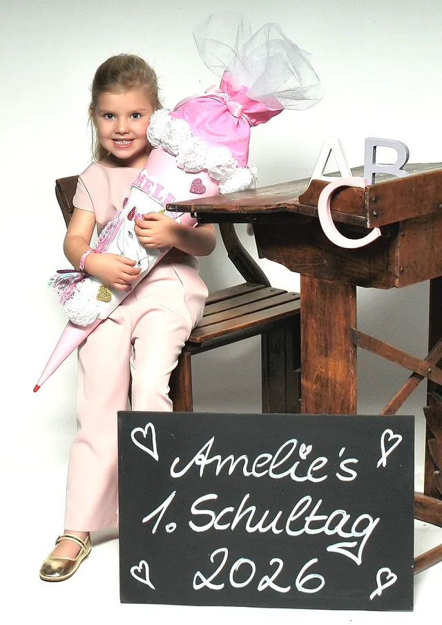 Einschulungsfoto mit Schultüte und Tafel im Fotostudio
